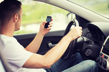 Image showing man using phone while driving the car