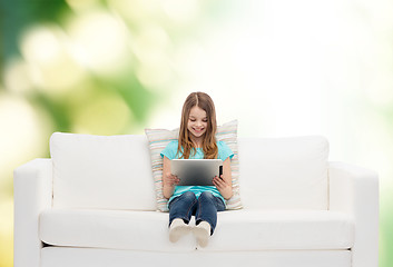 Image showing little girl sitting on sofa with tablet pc