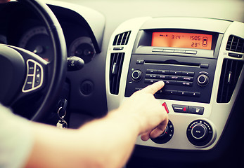 Image showing man using car audio stereo system