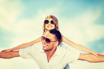 Image showing happy father and child in sunglasses over blue sky