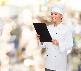 Image showing smiling female chef with black blank paper