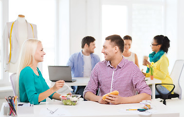 Image showing smiling fashion designers having lunch at office