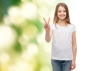 Image showing little girl in white t-shirt showing peace gesture