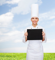 Image showing smiling female chef with black blank paper