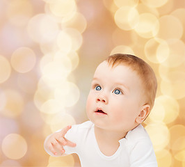 Image showing curious baby looking up