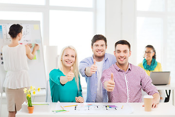 Image showing smiling interior designers working in office