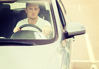 Image showing man placing parking clock on car dashboard