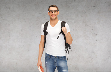 Image showing smiling student with backpack and book