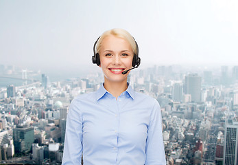 Image showing friendly female helpline operator with headphones