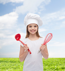 Image showing smiling girl in cook hat with ladle and whisk