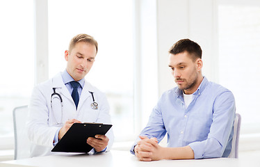 Image showing doctor with clipboard and patient in hospital