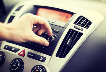 Image showing man using car audio stereo system