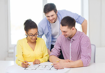 Image showing three smiling architects working in office