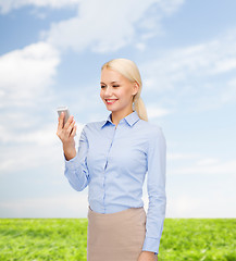 Image showing young smiling businesswoman with smartphone