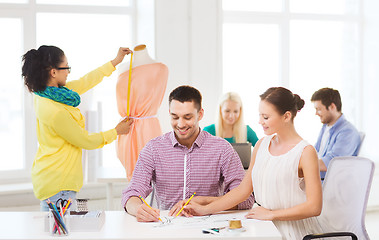 Image showing smiling fashion designers working in office