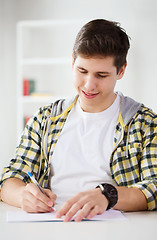 Image showing smiling student with textbooks at school