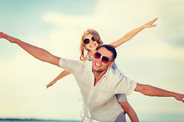 Image showing happy father and child in sunglasses over blue sky