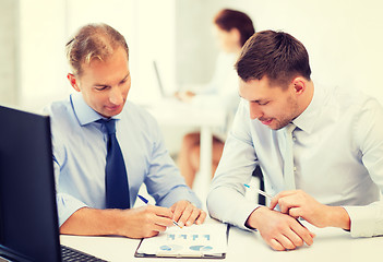 Image showing businessmen with notebook on meeting