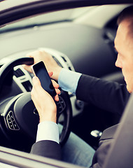 Image showing man using phone while driving the car