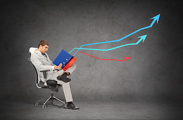 Image showing handsome businessman with folders sitting on chair