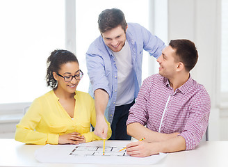 Image showing three smiling architects working in office