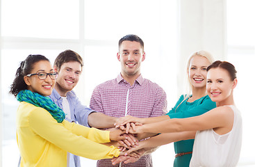 Image showing team with hands on top of each other in office