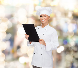 Image showing smiling female chef with black blank paper