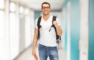 Image showing smiling student with backpack and book