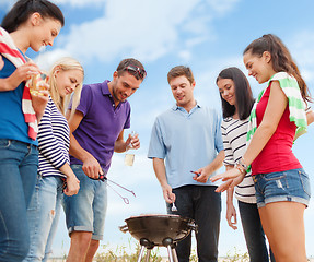 Image showing group of friends making barbecue on the beach
