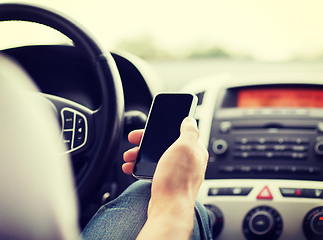 Image showing man using phone while driving the car