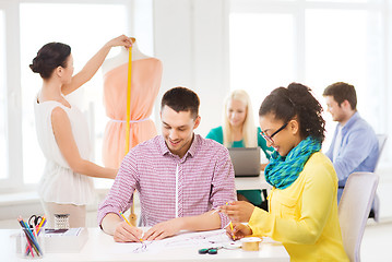 Image showing smiling fashion designers working in office