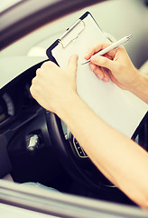 Image showing man with car documents