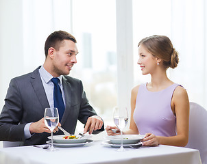 Image showing smiling couple eating appetizers at restaurant