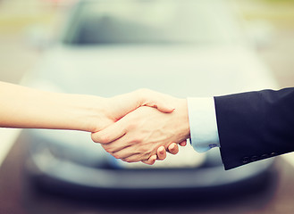 Image showing customer and salesman shaking hands