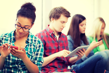 Image showing students looking into devices at school