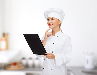 Image showing smiling female chef with black blank paper