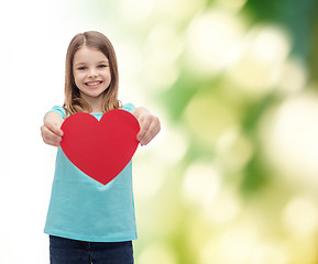 Image showing smiling little girl giving red heart