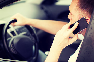 Image showing man using phone while driving the car