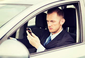 Image showing man using phone while driving the car