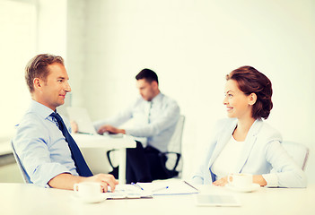 Image showing man and woman discussing something in office