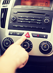 Image showing man pressing car hazard warning button