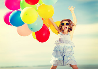 Image showing happy jumping girl with colorful balloons
