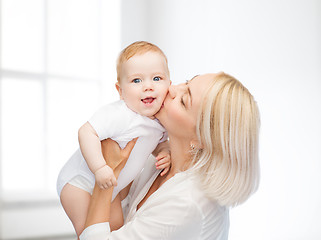 Image showing happy mother kissing smiling baby