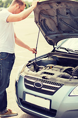 Image showing man opening car bonnet