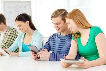 Image showing smiling students with tablet pc at school