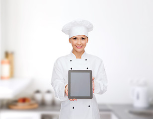 Image showing smiling female chef with tablet pc blank screen