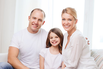 Image showing smiling parents and little girl at home