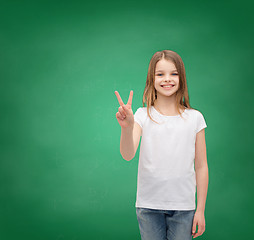 Image showing little girl in white t-shirt showing peace gesture