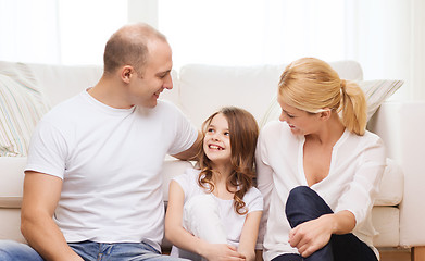 Image showing parents and little girl sitting on floor at home