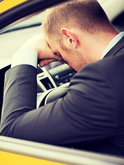 Image showing tired businessman or taxi car driver